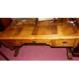 A Belgian oak kneehole desk, having three frieze drawers, raised on end cut supports, w.160cm