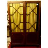 An early 20th century mahogany double door astragal glazed side cupboard, having interior hanging