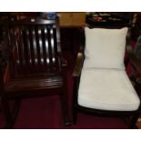 A stained teak slatted garden rocking elbow chair, w.62cm; together with a hardwood stickback open