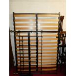 A Victorian style black painted wrought iron and brass double bed, having slatted inset fixed base