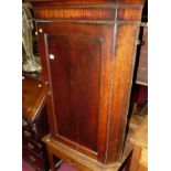 An early 19th century oak single door hanging corner cupboard, together with an early 19th century