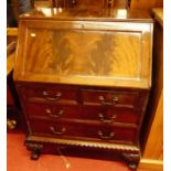 A Maple & Co mahogany and flame mahogany slopefront writing bureau, having two short over two long