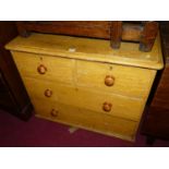 A Victorian scrumble finished pine round cornered low chest, of two short over two long drawers (