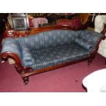 A mid-Victorian mahogany show frame three seater double scroll end sofa, having floral striped