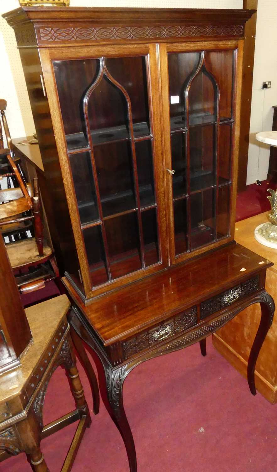 A circa 1900 mahogany double door glazed bookcase on stand, the stand with twin frieze drawers and