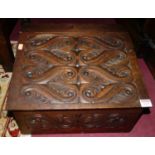 An early 20th century stained and floral relief carved softwood sloped hinge-top Bible box, w.41.
