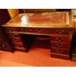 A reproduction mahogany and gilt tooled leather inset twin pedestal writing desk, w.136cm