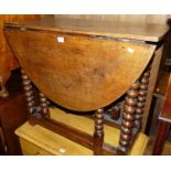 An 18th century joined and bobbin turned oak gateleg occasional table, having single end drawer