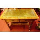 A Victorian Aesthetic Movement oak and burr oak two drawer writing table, having a gilt tooled green