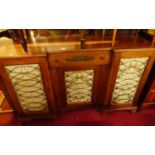 A mahogany inverted breakfront three door side cabinet, having central frieze drawer, in the