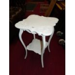 An Edwardian and later white painted floral decorated shaped top two-tier occasional table