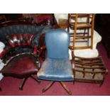 A contemporary mahogany and blue leather upholstered swivel desk elbow chair (damage to upholstery),