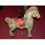 A painted and pressed metal child's horse