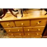 A contemporary pine side chest, fitted with three short drawers over four further longer lower