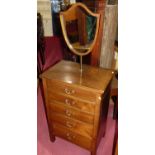 An Edwardian mahogany dressing chest, with integral rotating shield shaped mirror over an