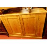 A late Victorian pitched pine double door side cupboard, w.145cm
