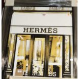 A reproduction print depicting Hermes of Paris window display, framed, 95 x 75cm