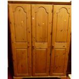 A modern Ducal pine three door wardrobe, w.145cm