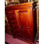A contemporary hardwood compactum chest, having six short drawers and single cupboard door, w.107cm
