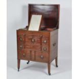 A late Georgian mahogany gentleman's fitted washstand, the hinged top opening to reveal well-