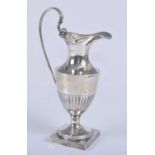 An Edwardian silver miniature ewer, of half-reeded form with beaded rims to a square base, having