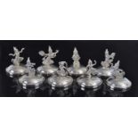 A set of eight early 20th century Siamese (Thai) loaded silver figural menu stands, each stamped
