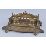 A late 19th century French gilt bronze encrier, the raised and pierced three-quarter gallery with