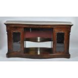 A Victorian rosewood marble-topped side cabinet, of serpentine outline, having twin glazed