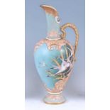 A Nautilus porcelain ewer, of slender baluster form, with gilt scroll acanthus leaf handle,