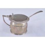 A George IV silver mustard pot, of half reeded circular form with angular hinged handle and shell