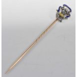 A yellow and white metal, enamel and diamond stick pin, depicting a fleur de lys emblem set with