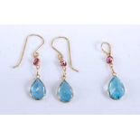 A pair of yellow metal, blue topaz and garnet drop earrings with matching pendant, earrings blue