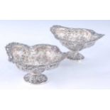 A pair of late Victorian silver pedestal bonbon dishes, of pierced and repousse decorated shaped