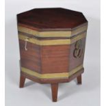 A Regency mahogany and brass bound wine cooler, of octagonal form, having zinc lined interior and