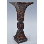 A circa 1900 Chinese carved tortoiseshell vase, of square trumpet form, the panels each carved
