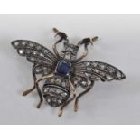 A yellow and white metal, sapphire and diamond winged insect brooch, comprising an oval sapphire set