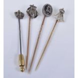 Four yellow and white metal diamond set royal monogram stick pins, one designed as an initial M