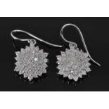 A pair of white metal diamond circular cluster earrings, each comprising 37 round brilliant cut