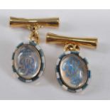 A pair of yellow metal reverse crystal cufflinks, each featuring the Royal monogram M surmounted