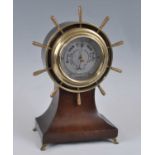 Henry Browne & Son Ltd of Barking & London - an oak ships wheel barometer, of balloon shape, with