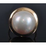 A yellow metal pearl dress ring, featuring a 14.8mm Mabé cultured pearl in a bezel setting, size N½,