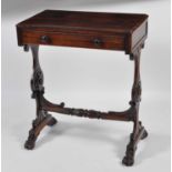 A Victorian rosewood needlework table, having a single frieze drawer and on shaped flower head