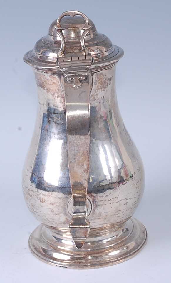 An early George III silver wine or beer jug, having a hinged domed cover, S-scroll handle, and - Image 4 of 6