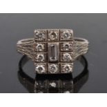 A white metal diamond rectangular cluster ring, comprising a centre baguette cut diamond within