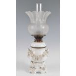 A 19th century blanc de chine porcelain oil lamp, the acid etched shade above a floral encrusted