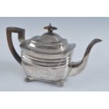 A George III silver teapot, of shaped rectangular form with banded decoration, walnut handle and