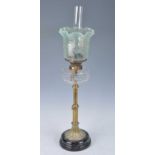 A Victorian brass oil lamp, having a vaseline glass shade and clear cut glass font above a plain