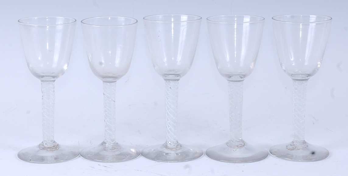 A set of five 18th century style wine glasses, each having a round funnel bowl above a mutliple