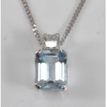 A white metal, aquamarine and diamond pendant, featuring a rectangular cut aquamarine suspended
