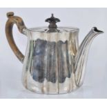 A George V silver teapot, of fluted lightly tapering circular form, having hinged fluted flat rim,